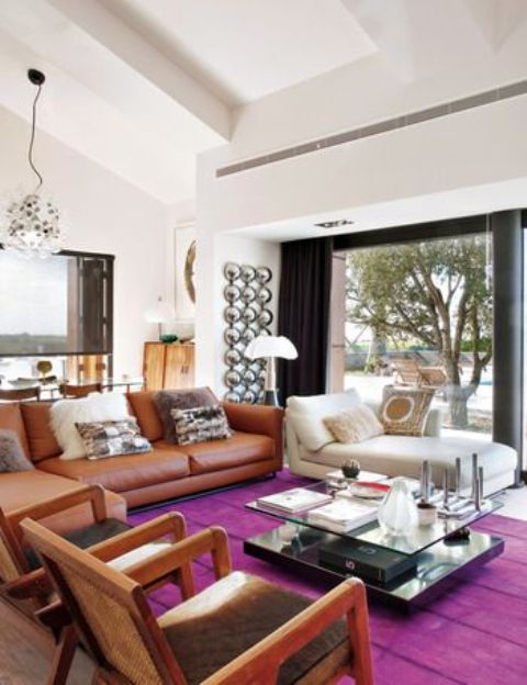 a bright and cozy mid-century modern living room with a magenta rug for a colorful touch