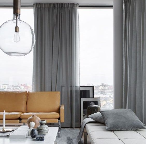 go for two types of draperies to keep the space warm and welcoming and still enjoy the views