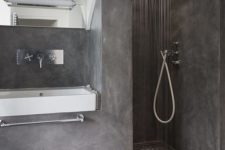 26 a full grey concrete bathroom with a mosaic floor in the shower, a very durable solution