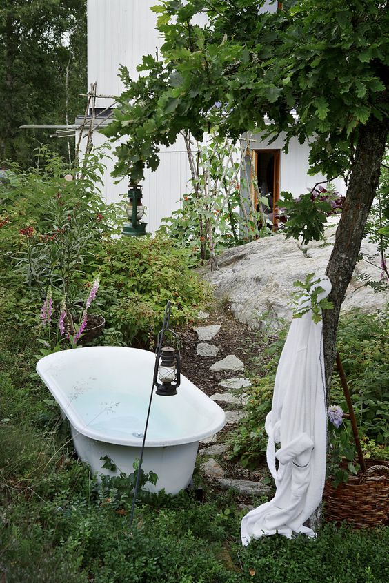 place your bathtub right in the greenery and under a tree and add lanterns to feel like in the wild