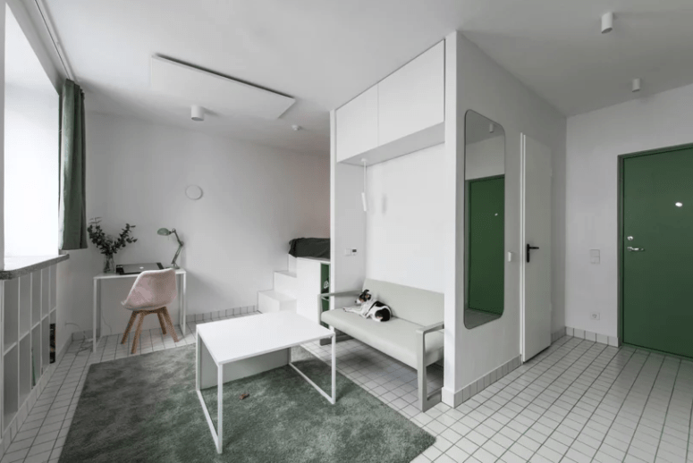 This tiny minimalist apartment features everything necessary for living and is done with old touches of green This tiny minimalist apartment features everything necessary for living and is done with old touches of green