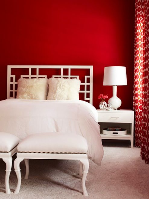 a red accent wall and red printed curtains plus white furniture make a gorgeous contrasting look