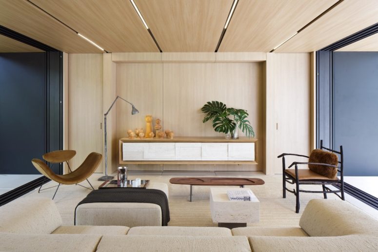 The interiors are done in a neutral color palette, with much wood and plywood, and dark touches add depth to the decor The interiors are done in a neutral color palette, with much wood and plywood, and dark touches add depth to the decor