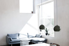 03 The living space is also here, with a blue sofa by the window to catch more sunlight