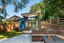 03 The shed is clad with glass and wood and is opened to the backyard