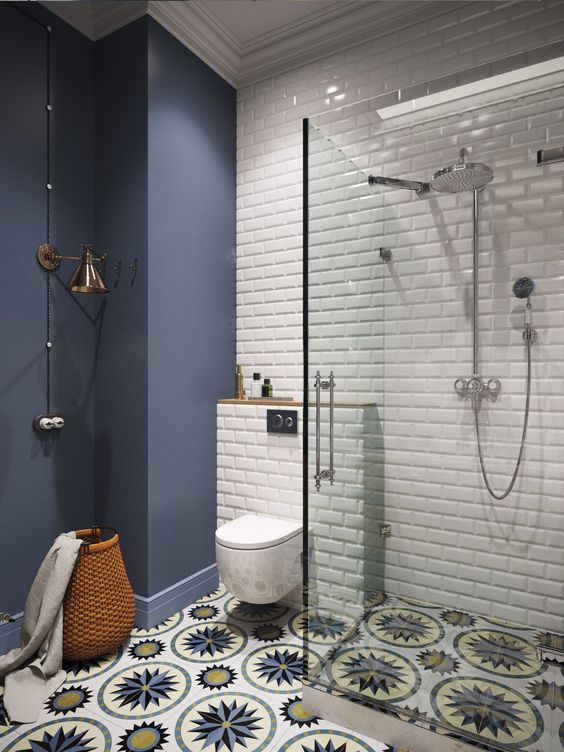 a matte midnight blue statement wall and a white glossy tile wall create a bold contrast