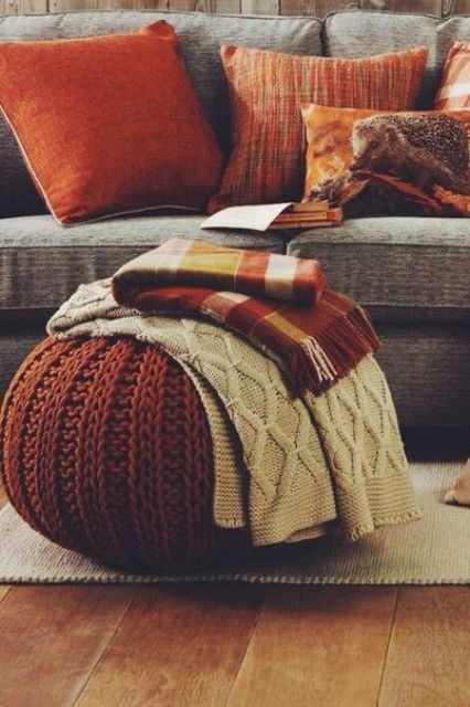 a touch of traditional fall color - rust is a great idea for any space, here it's added with pillows and a knit ottoman