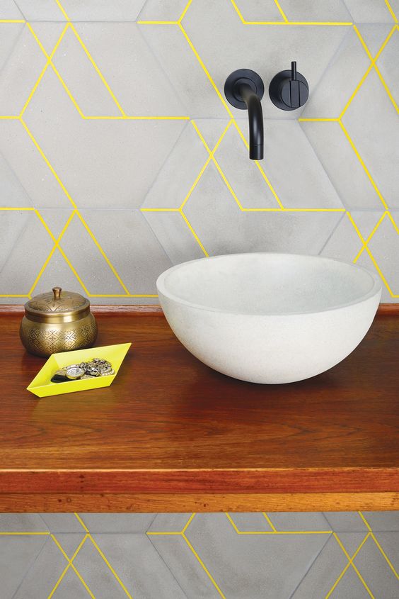 an ultra-modern bathroom look with geometric matte grey tiles and neon yellow grout