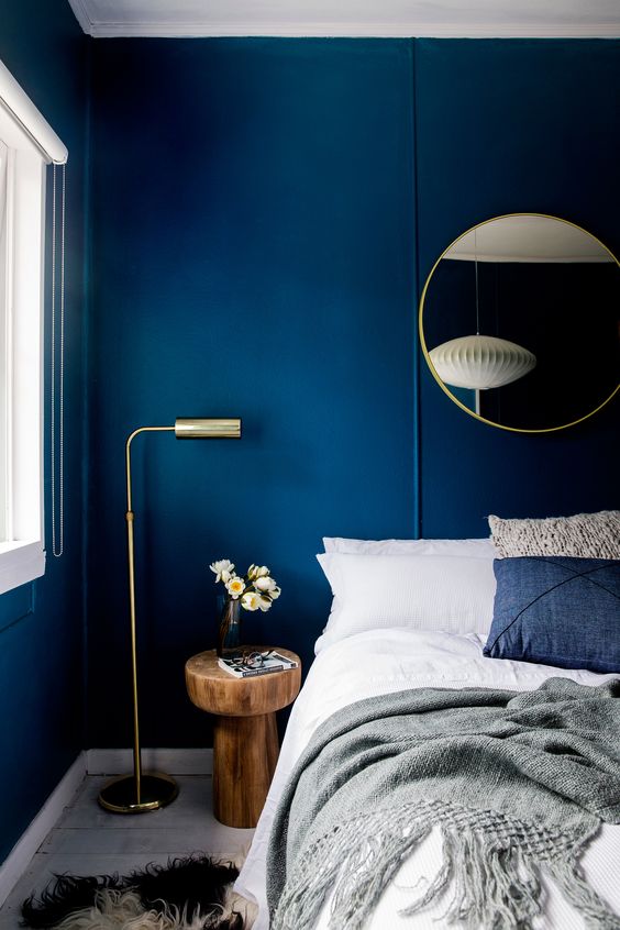 bold blue walls make a statement and look very chic with gilded touches