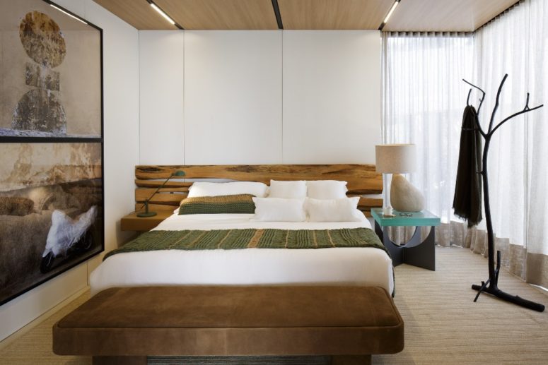 wooden headbord in rough style The bedroom is done with a comfy bed and a rough wood headboard, a window can be covered with curtains for privacy or uncovered to enjoy the views