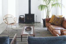 06 The living room features African aesthetics and modern comfy furniture, look at that vintage hearth