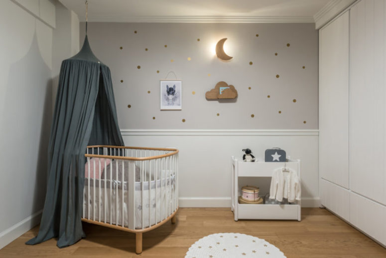 neutral nursery design The nursery is a peaceful space done in neutrals, with little gold accents and a slate grey canopy for a touch of color
