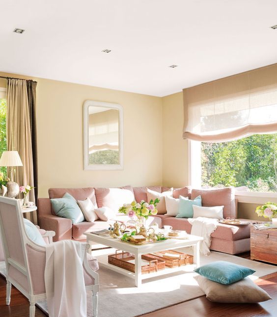 a cozy living room with tan as the main color, light pink as a secondary and pure white for refreshing