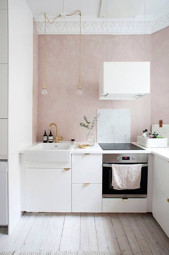 a glam feminine kitchen with blush walls, gilded touches and molding is a chic space you'll never want to leave