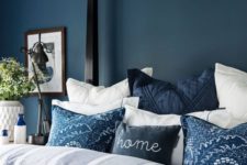 06 a navy statement wall plus naxy pillows and a blanket contrast whites and make the space relaxing