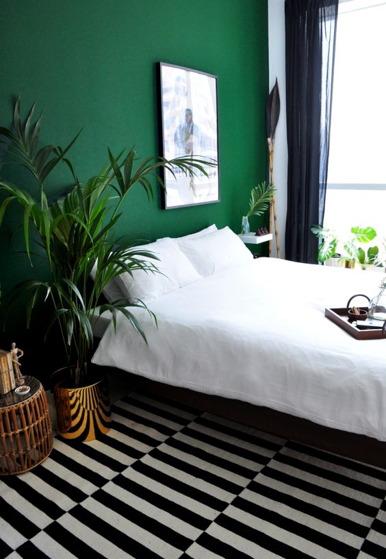 an emerald accent wall will refresh the bedroom and add color to the space