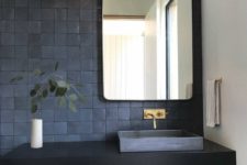 06 gorgeous matte midnight blue tiles on the wall and a matching sink create a trendy moody look