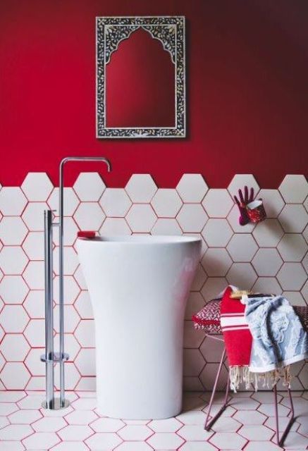 hot red grout matches the painted part of the wall and makes the bathroom more unified