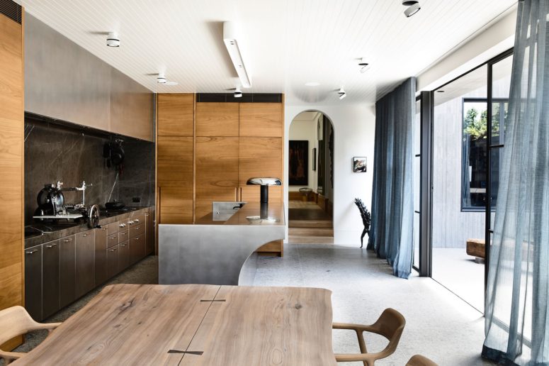 The kitchen is done with plywood and metal cabinets and a gorgeous metal kitchen island with curved lines, it may be opened to outdoors The kitchen is done with plywood and metal cabinets and a gorgeous metal kitchen island with curved lines, it may be opened to outdoors