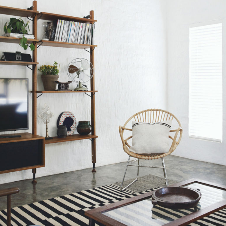 The shelving unit is an open one to keep the airy feeling on, and dark stained wood adds a contrasting touch The shelving unit is an open one to keep the airy feeling on, and dark stained wood adds a contrasting touch