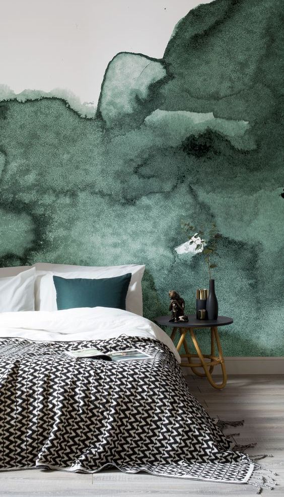 a dark green watercolor accent wall is a great statement in this bedroom, add a matching piece like a pillow here