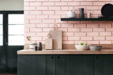 07 a pink quartz brick wall and black wooden plank cabinets make up a stylish look with a lot of texture