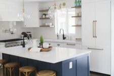 07 a white kitchen is spruced up with a navy kitchen island and a white countertop adds color to the space