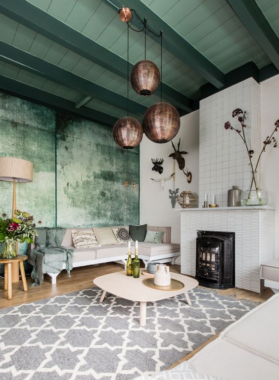 the living room accented with greens and with grey as an additional color looks peaceful