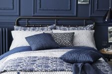 08 a dark blue wall with wainscoting and matching pillows for a relaxing moody space