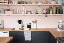 08 blush walls and shelves contrast the black cabinets and create a chic and stylish color combo