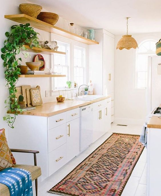give your kitchen a boho feel using boho rugs, pillows, towels, greenery and wicker touches