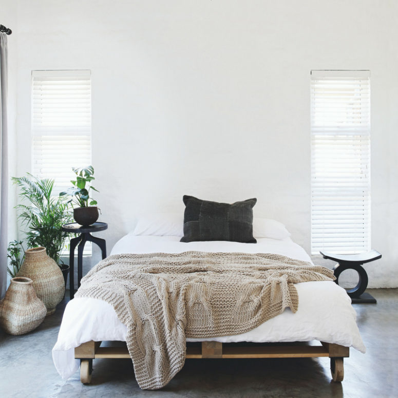 The master bedroom is done with a pallet bed on casters, some wicker baskets and catchy black furniture The master bedroom is done with a pallet bed on casters, some wicker baskets and catchy black furniture