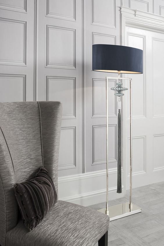 a gorgeous floor lamp with a matel base, a navy lampshade and a cool pendant plus a long tassel