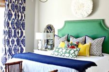 11 a bright green upholstered bed and a bold rattan bench with a palm leaf print