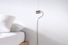 11 a minimalist floor lamp with a thin metal base and a small spotlight for a minimalist bedroom
