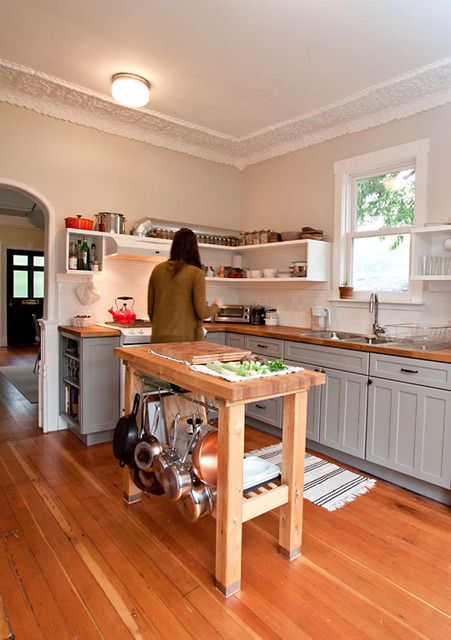 https://www.digsdigs.com/photos/2018/08/12-a-mini-free-standing-kitchen-island-of-wood-with-much-storage-space-and-a-pan-holder.jpg