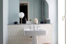 12 a pale blue wall and a creamy tile accent for a subtle and delicate look in your bathroom