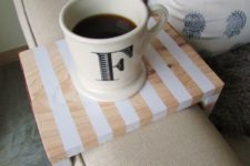 12 a small sofa caddy with stripes is nice to hold a drink or a small gadget of your choice