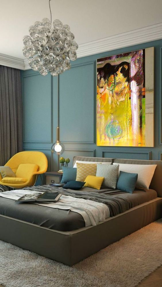 an earthy bedroom done with green and bold yellow touches that make it stand out