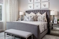 13 a bedroom in different shades of grey is spruced up with a seaside gallery wall and a large crystal chandelier