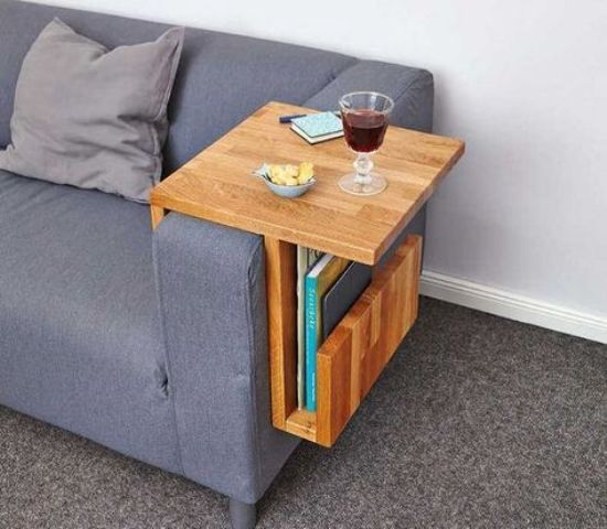 a stylish plywood sofa caddy with geometric lines features a top for drinks and gadgets and a pocket for books and magazines