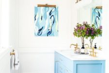 14 a blue bathroom vanity plus brass fixtures create a chic and refined feel in the bathroom