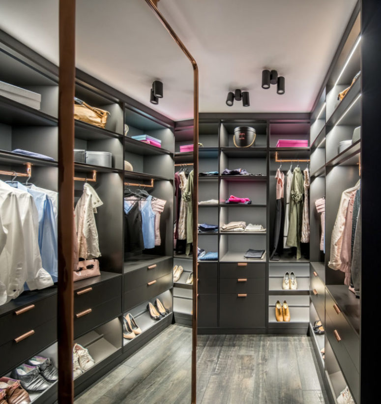 The closet features everything necessary for storing clothes and shoes with style and lots of light