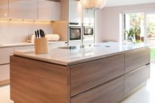 15 a neutral glam kitchen with a wood clad kitchen island to add texture and interest to the space