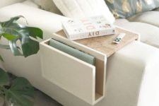 15 a small sofa caddy with white and stained parts features a small top and a pocket for storage