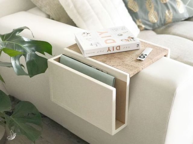 a small sofa caddy with white and stained parts features a small top and a pocket for storage
