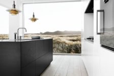 16 a sleek white kitchen that contrasts a black wooden kitchen island to create a bold minimalist look