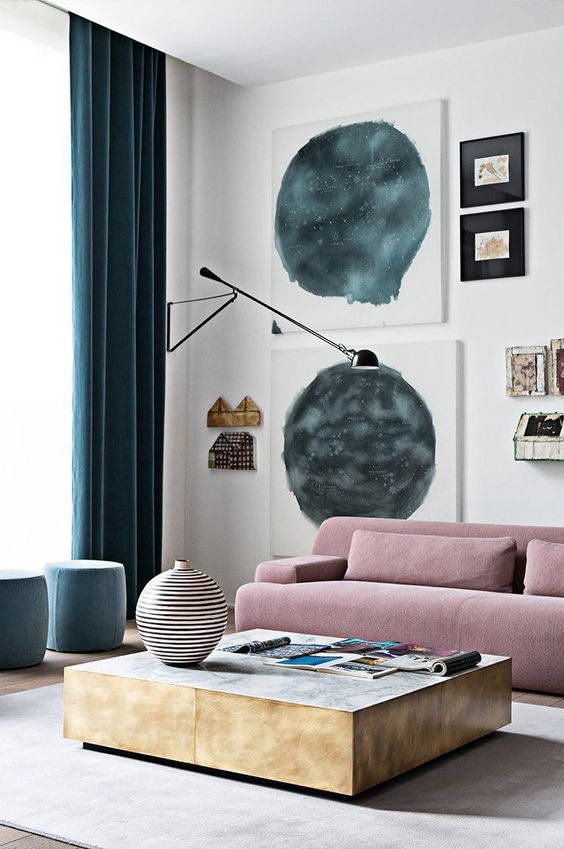 a contemporary living room done with teal and dusty pink accents for a bold look