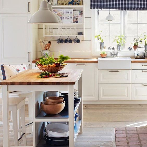 a small farmhouse kitchen island with plenty of storage and a meal space is a practical idea