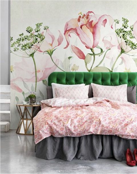 an emerald upholstered bed echoes the amazing floral mural on the headboard wall